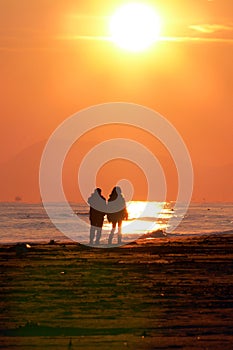 Walking on the beach at sunrise