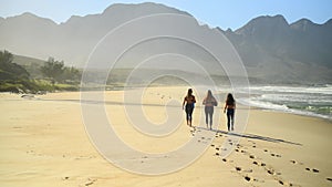 Walking, beach and women with nature, exercise and training with fitness, summer and weekend break. People, group and