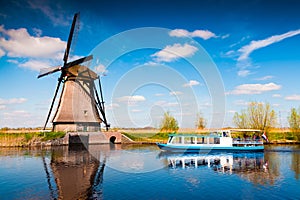 Walking boat on the famoust Kinderdijk canal with windmills