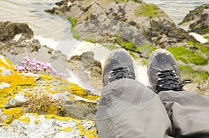 Walking boots with beach in background