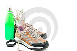 Walking boots and world map and water bottle on white background