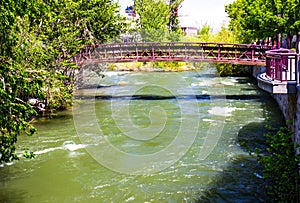 Walking Bridge Over Rushing River