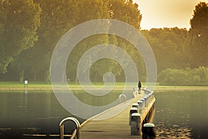 Walking on a bridge to the golden sunrise