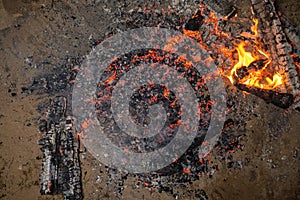 Walking on the burning cinders close-up side view.