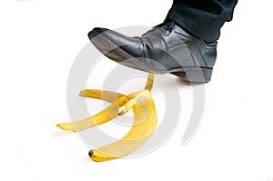 Walking businessman is going to slip on banana peel