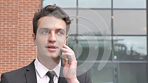 Walking Businessman Talking on Phone