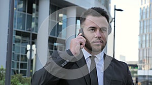 Walking Businessman Talking on Phone