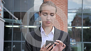 Walking Businesswoman Busy Using Smartphone Ouside Office