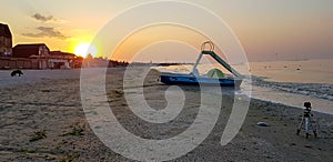 Walking catamaran against the backdrop of sunrise on the sea.