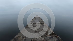 Walking on a concrete stone pier on the seashore