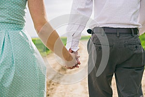 Walking couple holding hands