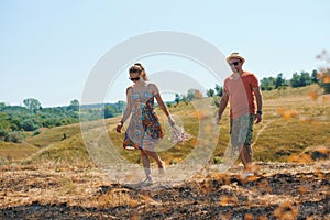 Walking couple in sunglasses