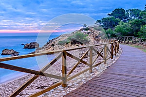 Walking at dawn by the beach of the Portitxol Costa Brava, Catalonia, Spain photo