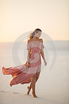 Walking in Desert Fashionable Woman Model in Evening Pink Dress