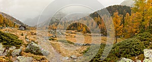 Walking at fall in a cloudy day in a mountain valley