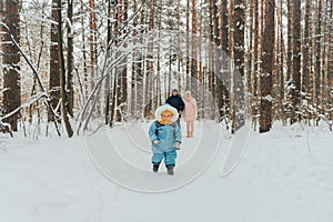 Walking family with a child. Family walks in nature in winter. Winter family walk in nature. A lot of snow