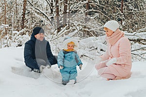 Walking family with a child. Family walks in nature in winter. Winter family walk in nature. A lot of snow