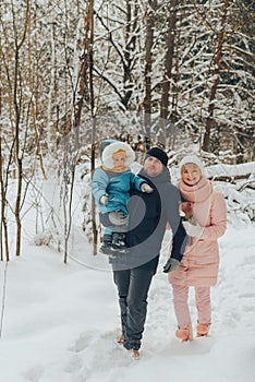 Walking family with a child. Family walks in nature in winter. Winter family walk in nature. A lot of snow