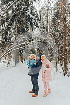 Walking family with a child. Family walks in nature in winter. Winter family walk in nature. A lot of snow