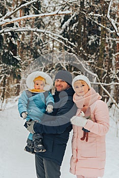 Walking family with a child. Family walks in nature in winter. Winter family walk in nature. A lot of snow