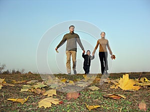 Walking family sundown autumn leaves