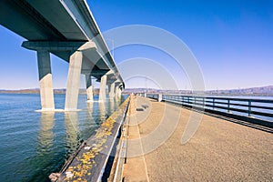 Walking on the fishing pier situated next to Dumbarton Bridge, connecting Fremont to Menlo Park, San Francisco bay area,