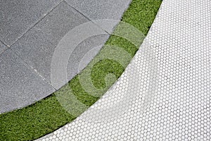 Walking foot path with green grass and tiles background texture