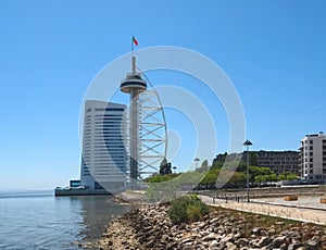 Walking the footpath Passeio do Tejo along Tagus river in Lisbon at the Expo park - with the tower photo