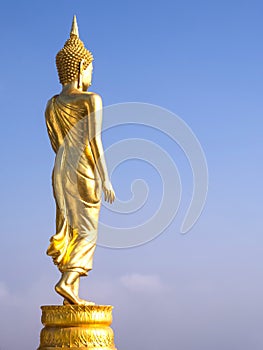 Walking golden buddha statue viewpoint in Nan