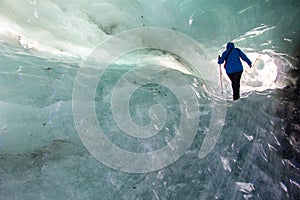 Walking through an ice cave with blue ice