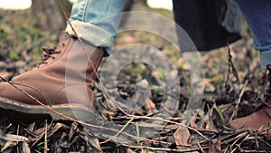 Walking legs in brown shoes side view. Walking feet in brown leather boots