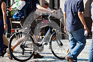 Walking man with a bicycle in the city