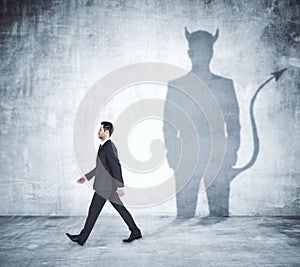 Walking man with devil shadow