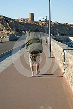 Walking man with enormous backpack