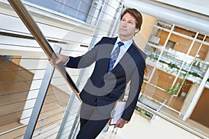 Walking, office and business man on stairs with documents, paperwork and clipboard. Professional, corporate lawyer and