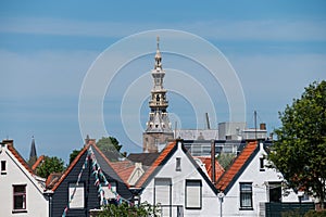 Walking in old Dutch town Zierikzee with old church tower, small houses and streets