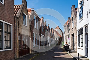 Walking in old Dutch town Zierikzee with old small houses and streets