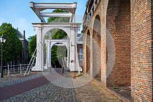 Walking in old Dutch town Zierikzee with old white bridge, small houses and streets