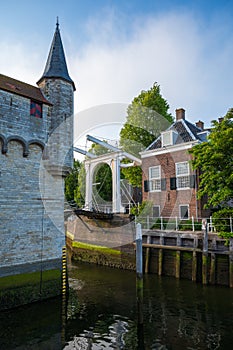 Walking in old Dutch town Zierikzee with old white bridge, small houses and streets
