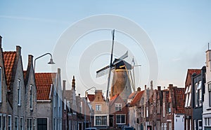 Walking in old Dutch town Zierikzee with old windmill, small houses and streets