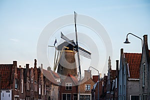 Walking in old Dutch town Zierikzee with old windmill, small houses and streets