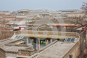 Walking past the tiled roofs in the old town of Pingyao
