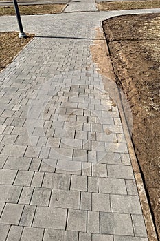 A walking path in the form of paving stones in the park for walking in free time for people in the summer