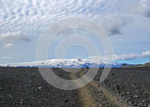 Walking path throw volcanic black sand desert landscape, Laugavegur Trail from Thorsmork to Landmannalaugar, Highlands of Iceland