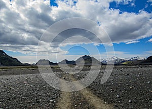 Walking path throw volcanic black sand desert landscape, Laugavegur Trail from Thorsmork to Landmannalaugar, Highlands of Iceland