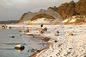 Walking people on the coast of sea at winter time