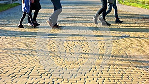 Walking people on the cobbles.