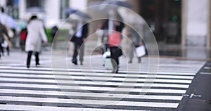 Walking people on the street in Marunouchi Tokyo rainy day