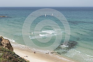 Walking and Playing on the Mediterranean Beach at Netanya in Israel with Small Boats in Sea