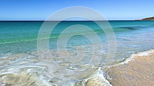 Walking POV of wave breaking gently on Bunker bay beach, near Dunsborough.